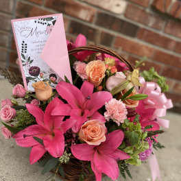 Pink flower basket with lilies, roses, and a Mother's Day card