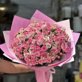 Large bouquet of pink roses wrapped in pink paper
