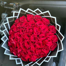 Large bouquet of red roses wrapped in geometric black and white paper