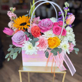 Colorful mixed flower basket with roses, tulips, and daisies