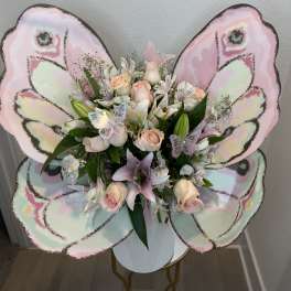 Butterfly-shaped bouquet with pale pink roses and lilies