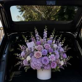 Lavender rose and hydrangea arrangement in a white vase
