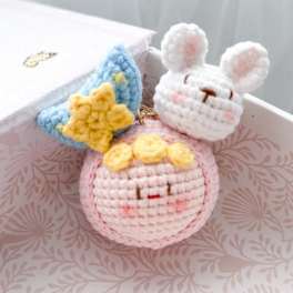 Crocheted bunny and star charms in a gift box