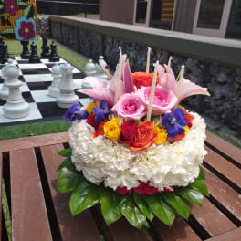 Colorful floral arrangement with roses and lilies on a table