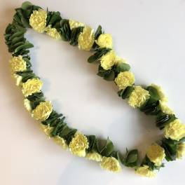 Yellow flower lei with green leaves on a white background