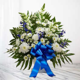 White daisy bouquet with blue flowers and a large blue ribbon