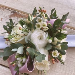 White rose bouquet with small white blossoms and a lavender ribbon