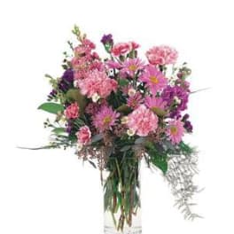 Pink and purple mixed bouquet in a clear glass vase