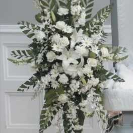 Tall white floral standing spray with lilies and daisies