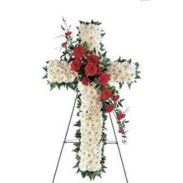 Standing floral cross with white and red flowers on an easel
