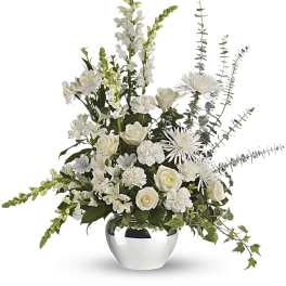 White floral arrangement in a silver vase with roses and tall spiky blooms