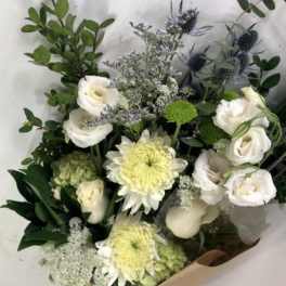 Bouquet of white roses and pale yellow chrysanthemums with greenery