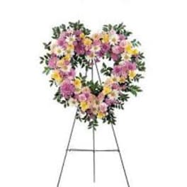 Heart-shaped floral wreath on a metal easel
