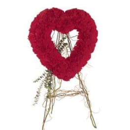 Red floral heart-shaped wreath on a twig stand