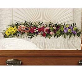 Colorful floral casket spray with roses and mixed blooms
