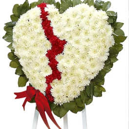 Heart-shaped white and red floral tribute on a stand
