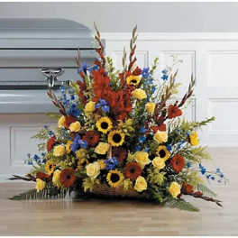 Large basket arrangement with sunflowers, roses, and blue flowers