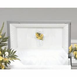 White casket with a small yellow floral spray