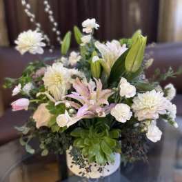 White and pink floral arrangement in a white vase