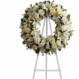 White floral wreath on a white easel stand