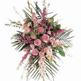 Pink floral spray with long palm fronds and mixed blossoms