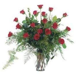 Tall bouquet of red roses in a clear glass vase