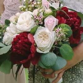 Bouquet of red and white roses with green foliage