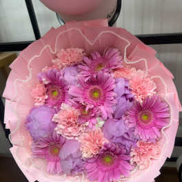 Pink and lavender bouquet with gerbera daisies and carnations wrapped in pink paper
