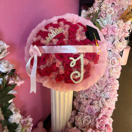 Pink and red rose bouquet with a graduation cap and tiara