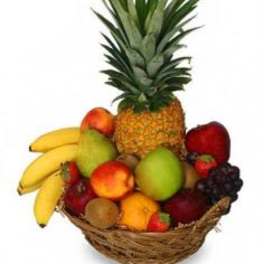 Fruit basket with pineapple, bananas, apples, grapes, and other fruit