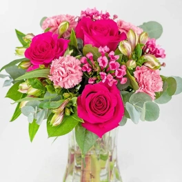 Pink rose bouquet in a clear glass vase