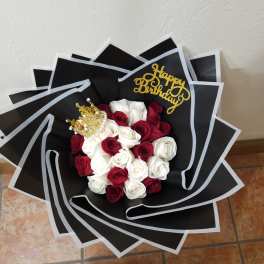 Bouquet of red and white roses with a gold birthday topper