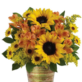 Sunflower and orange alstroemeria bouquet in a striped ceramic pot