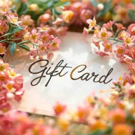 Pink flowers surrounding a gift card sign