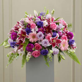 Stargazer, gerbera and rose casket spary