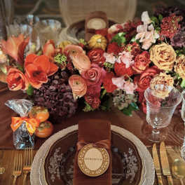 Autumn table setting with a large floral centerpiece and place settings