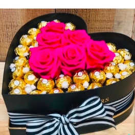 Heart-shaped box with pink roses and gold-wrapped chocolates