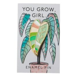 Enamel pin on a card with a potted plant illustration and the words "You grow, girl."