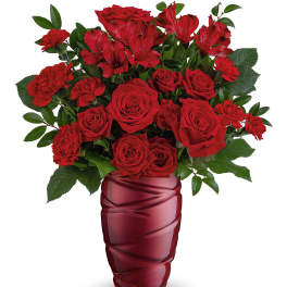 Red roses and carnations in a red glass vase