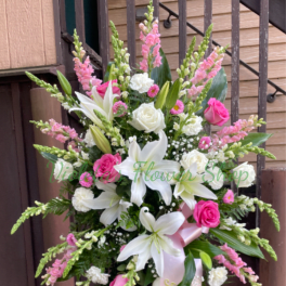 Tall pink and white floral standing spray with lilies and roses