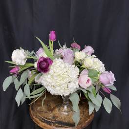 Pink and white floral arrangement in a clear glass vase
