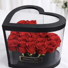 Heart-shaped black box filled with red roses