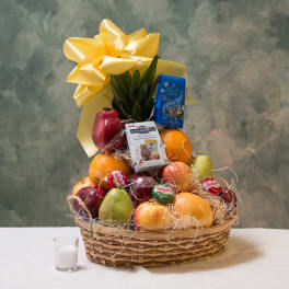 Fruit basket with chocolates and a large yellow bow