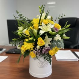 Yellow and white mixed bouquet in a white cylindrical box
