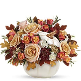 Autumn floral arrangement in a white pumpkin-shaped vase