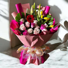Pink bouquet with roses, tulips, and a red gerbera daisy