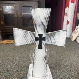 Decorative cross-shaped memorial piece in a clear vase