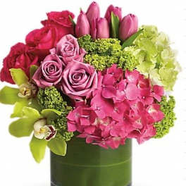 Pink roses and tulips with hydrangea in a glass vase