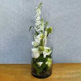 White floral arrangement in a tall clear glass vase
