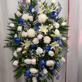 Standing funeral spray with white and blue flowers